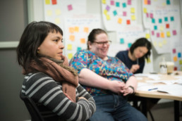A group of participants sit together to talk about their goals